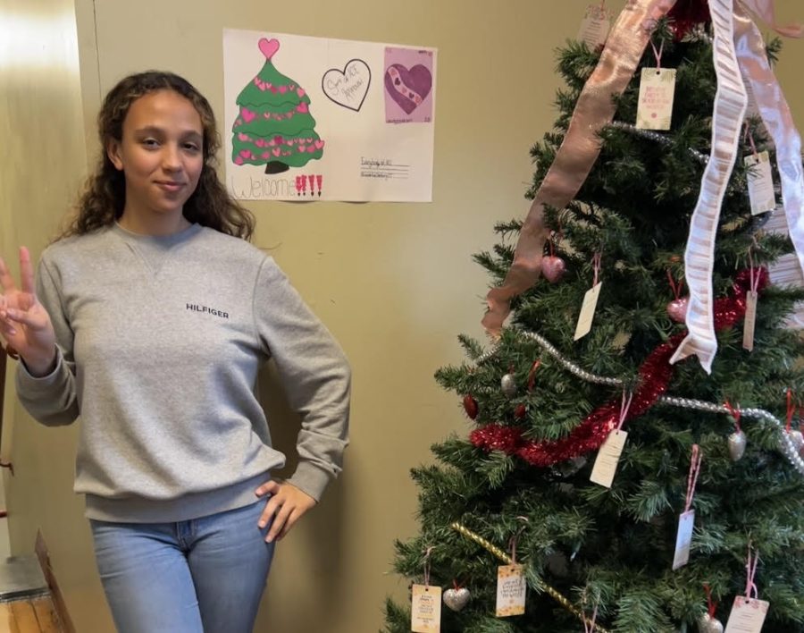 Ludmila Conceicao standing next to ACEs Kindness Tree.