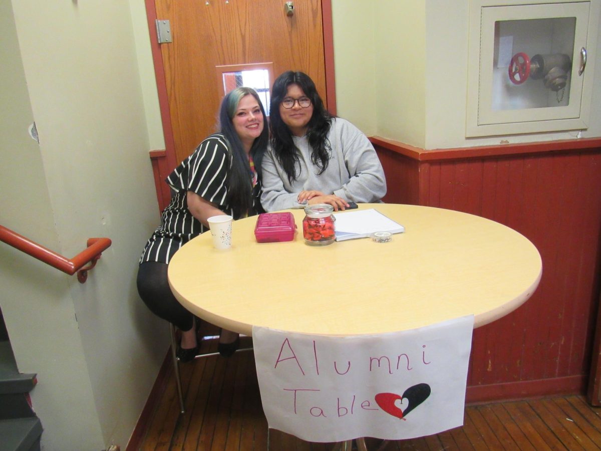 ACE teacher and student at the alumni table working