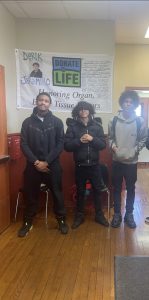 Jalen, Jamauri, and Elijah p. standing in the ACE hallways as new students 