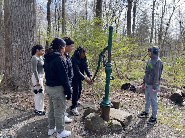 Gregs gym class stopping by a water well on one of many hiking adventures.