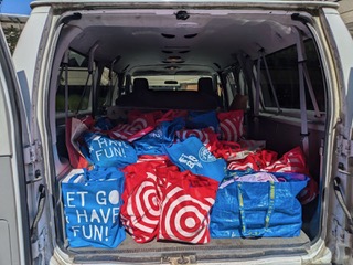 The van filled with all the school supplies that were organized. 