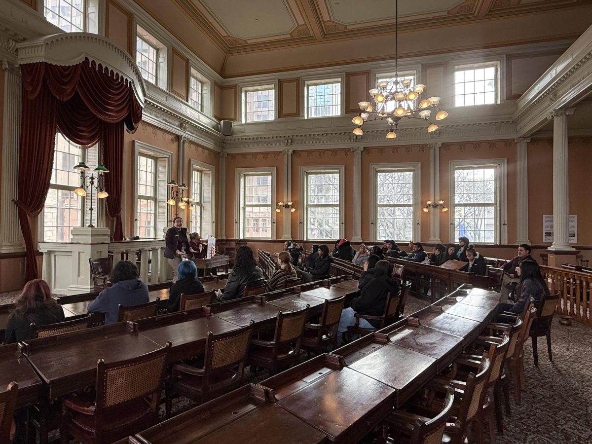 Students participate in a discussion in the House of Chambers at the Old State House.