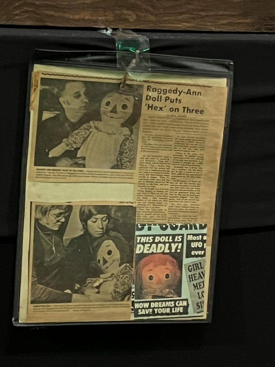 News clippings about Annabelle hang from a display at Paracon in 2022.